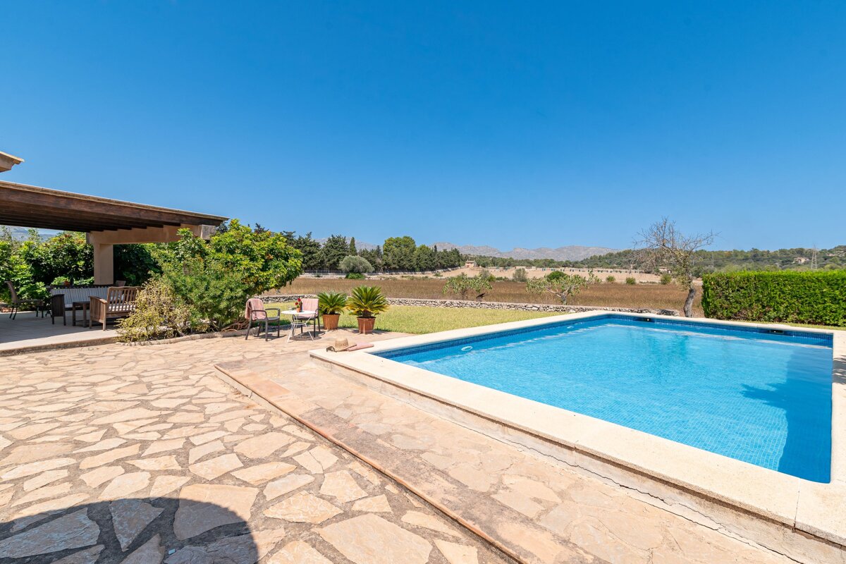 A large swimming pool in the backyard of a house