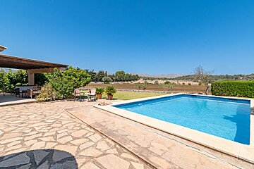 A large swimming pool in the backyard of a house