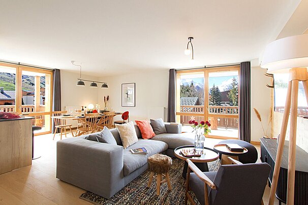 A living room with a couch a chair and a table