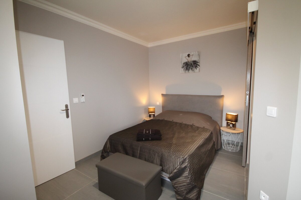 A bedroom with a bed and a painting on the wall