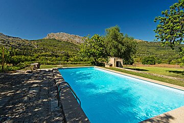 A large swimming pool with a mountain in the background