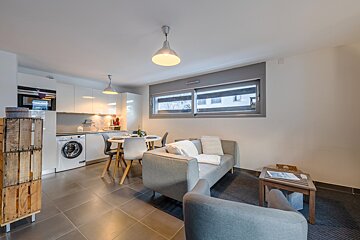 A living room with a couch and a table