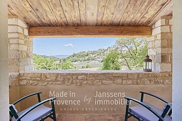 A balcony with two chairs and the words made in provence by immobilier