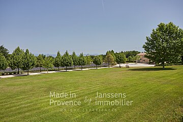 A lush green field with the words made in provence by immobilier