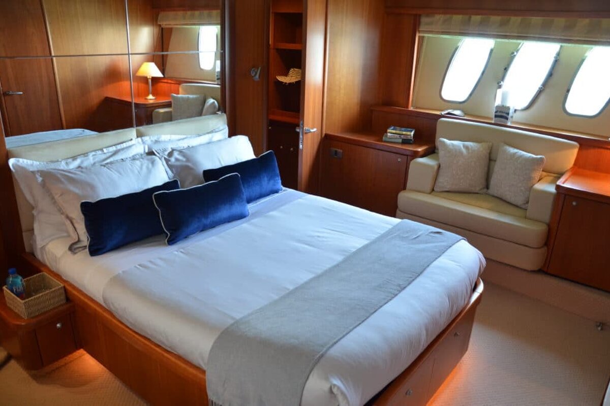 A bedroom with a large bed and a couch