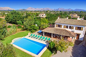 A large house with a swimming pool in front of it