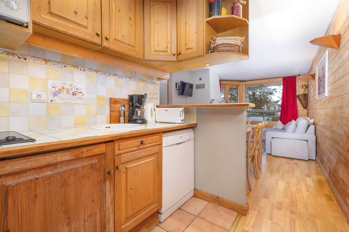 A dining room with a table and chairs and a chandelier