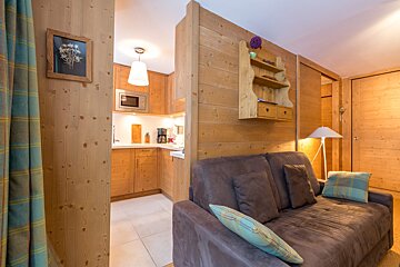 A snowy landscape with trees and mountains in the background