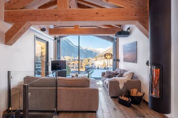A living room with a couch that has a sign on it that says 