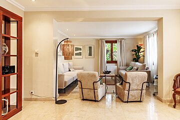 A living room with a couch and two chairs