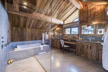 A bathroom with a tub and a walk in shower