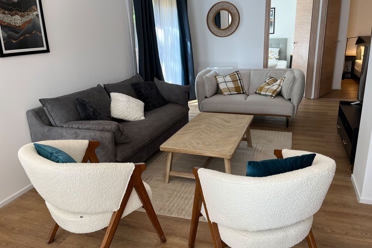 A living room with a couch and two chairs