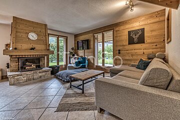 A living room with a fireplace and a clock on the wall
