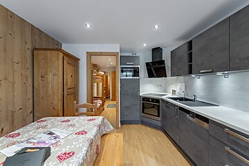 A kitchen with a table that has a magazine on it