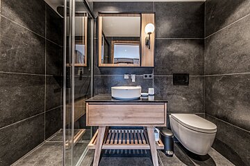 A bathroom with a toilet a sink and a mirror