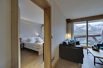 A hotel room with a bed and a couch