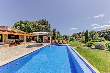 A large swimming pool in front of a house