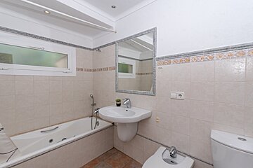 A bathroom with a bathtub sink and toilet