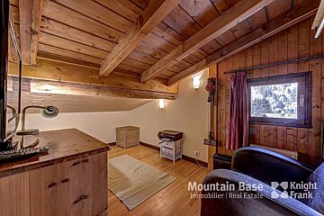 A room with a wooden ceiling and the words mountain base knight frank on the bottom