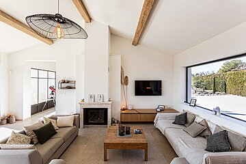 A living room with a fireplace and a flat screen tv
