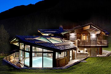 A house with a large swimming pool inside of it