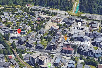 An aerial view of a city with bakery supermarket and train stop