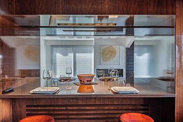 A dining room table with plates and glasses on it