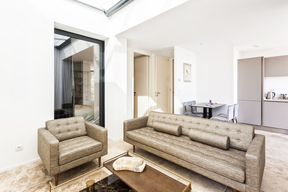 A living room with a couch and two chairs