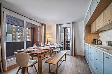 A living room with a dining table and chairs