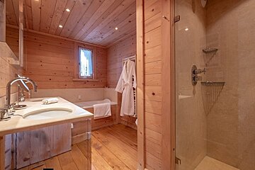 A bathroom with a sink and a walk in shower