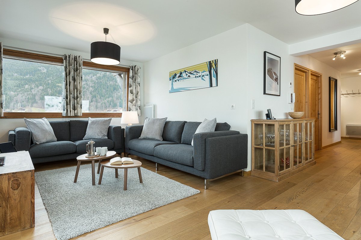 A living room with a couch and two coffee tables