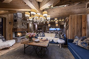 A living room with a couch a table and a fireplace