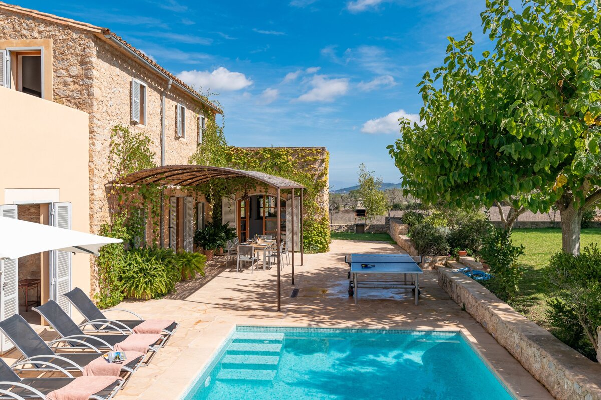 A large swimming pool in front of a house