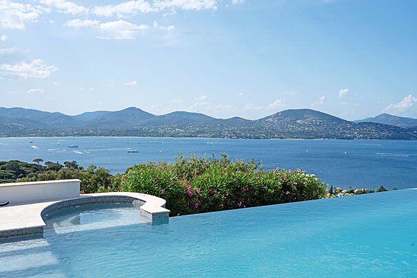 A swimming pool with a view of the ocean and mountains