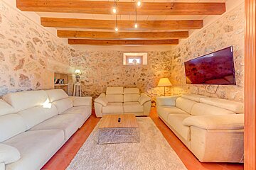 A living room with white couches and a flat screen tv