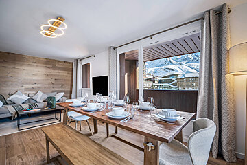 A dining room table with plates and glasses on it