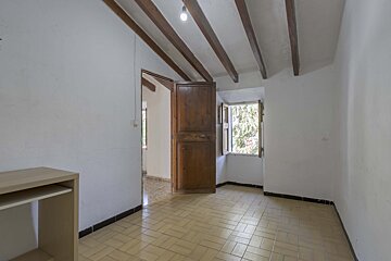 An empty room with a wooden door and a window