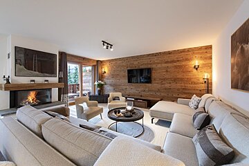 A living room with a couch and chairs and a fireplace