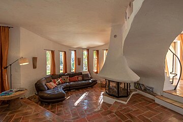 A living room with a couch and a fireplace