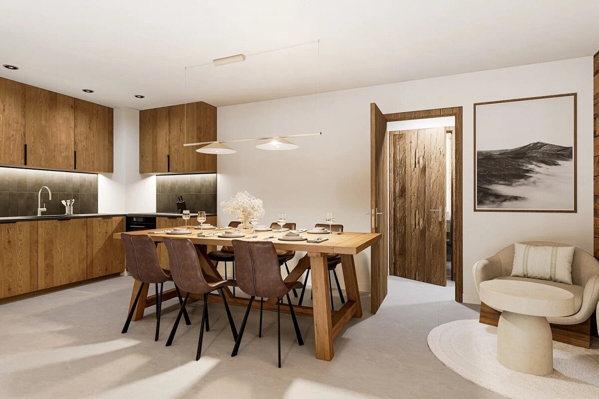 Modern kitchen and dining room with warm wood cabinetry, a large set dining table, and an inviting armchair. Rustic-chic design.