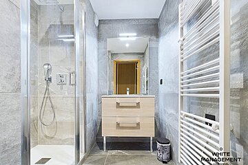A bedroom with bunk beds and a rental designer logo
