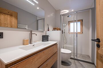 A bathroom with a toilet and a sink and a bag that says ' eduscho ' on it
