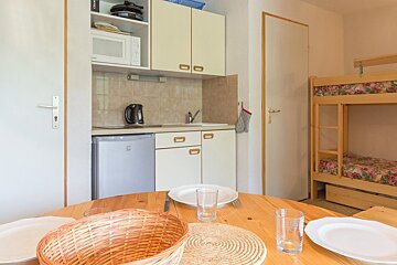 A wicker basket sits on a table in a kitchen