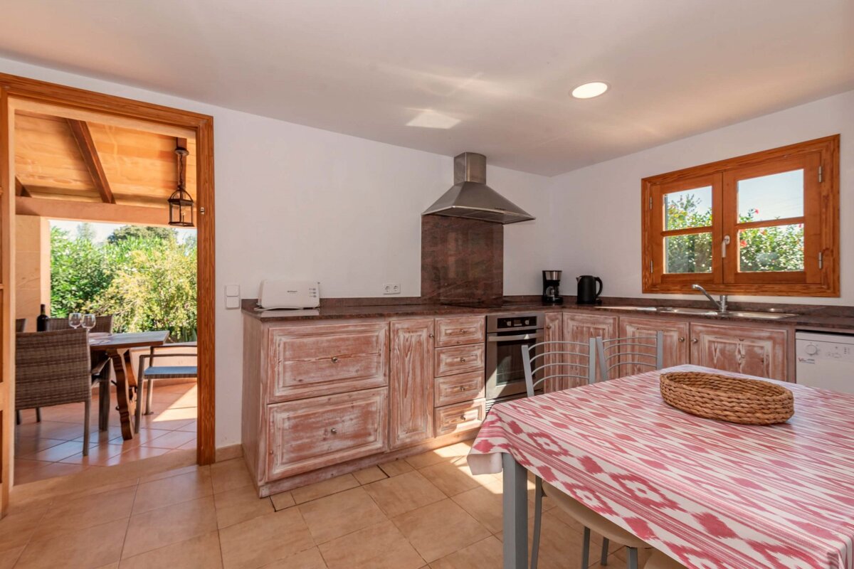 A kitchen with a table and chairs and a microwave