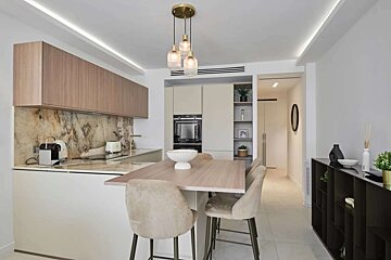 A kitchen with a table and chairs in it