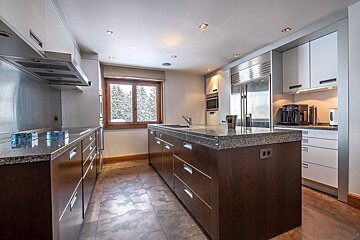 A kitchen with stainless steel appliances and granite counter tops