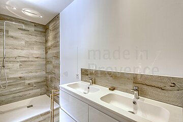 A bathroom with two sinks and a shower that says made in provence
