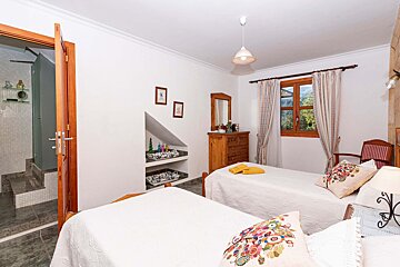 A bedroom with two twin beds and a dresser