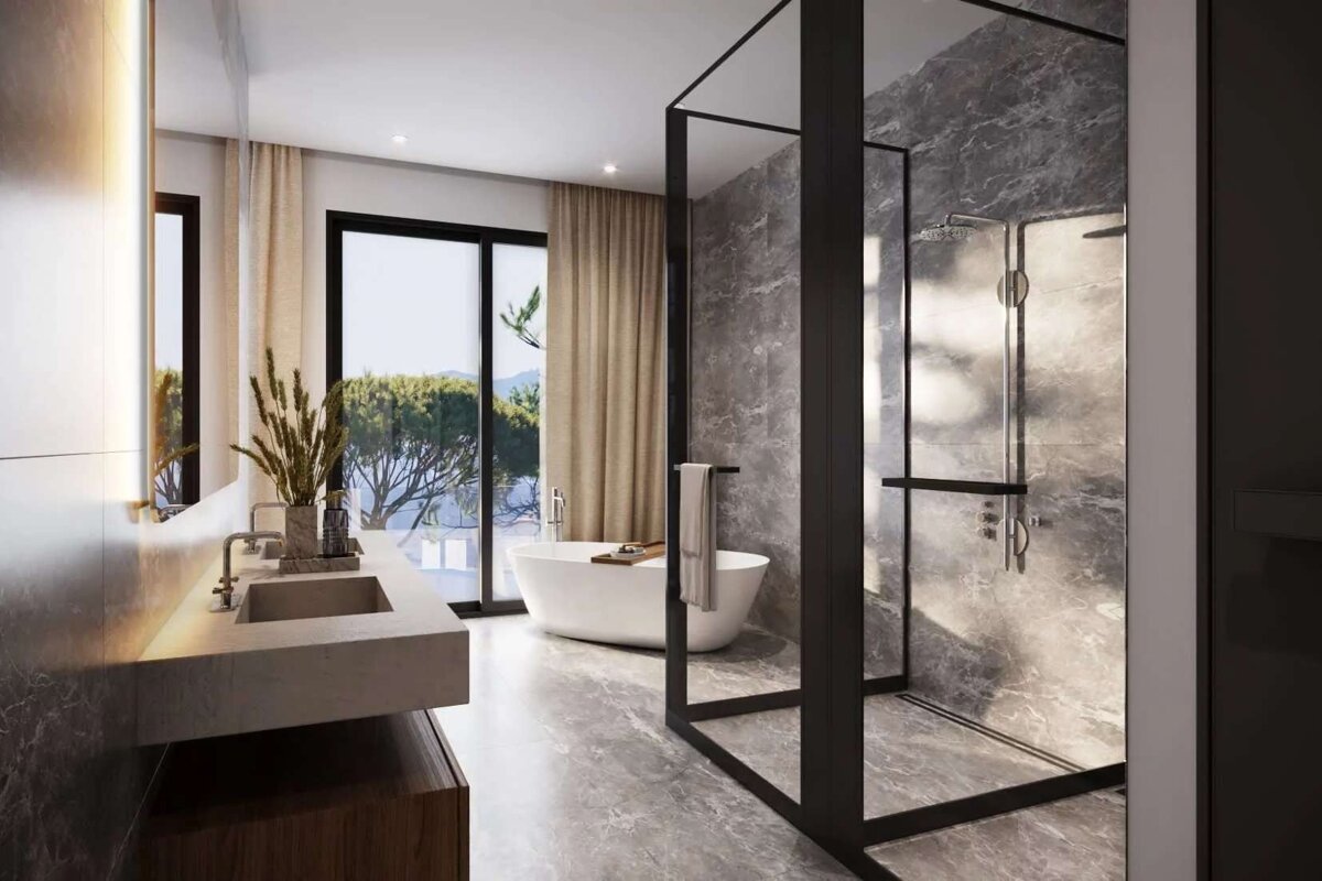 A modern, luxurious bathroom with a freestanding tub, walk-in glass shower, double vanity, and a large window offering a stunning natural view.