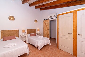 A bedroom with two beds and a sliding barn door